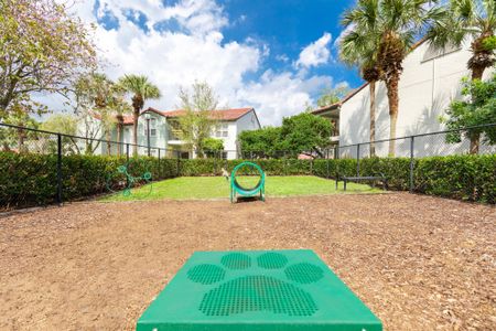 Small gated dog park outside Mira Flores apartments, a pet friendly rental community in Palm Beach.