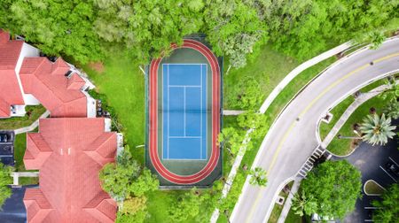 Birds-eye view of a tennis court outside apartments for rent in Palm Beach Gardens.