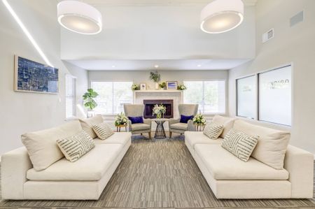 Avana Vista Point Clubhouse lounge sofas with soft lighting, nuetral color palette and fireplace