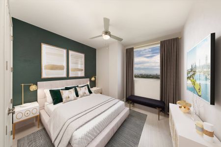 Model bedroom at our apartments in Fort Lauderdale, featuring wood laminate floors, a green wall, and white bedspread. Digitally staged photo.
