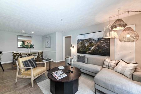Renovated living room in an apartment for rent in Acworth, GA. Hardwood floors and elegant décor.