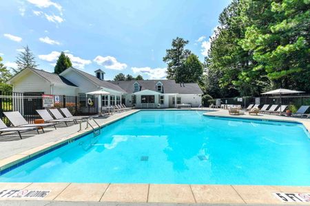 Community pool with sun tanning and lounge chairs with apartments for rent in Acworth, GA.