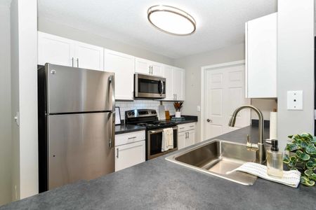 Kitchen, stainless steel range, white cabinets and pantry
