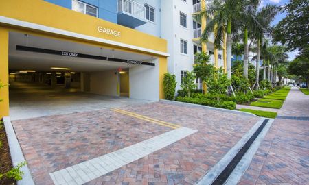 The parking garage at our apartments for rent in Boca Raton, featuring a view of the entrance and apartment complex.