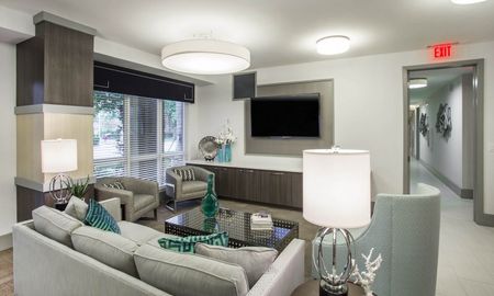 City Walk Apartments resident lounge with seating and television.
