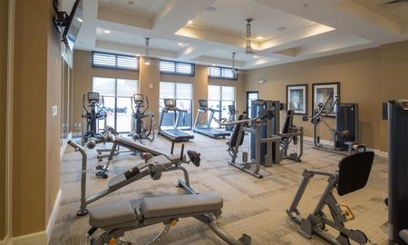 Gym with several units of exercise equipment in apartments for rent in Boca Raton.