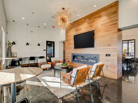 Resident lounge with modern lighting and a wooden partition at the preserve apartments.