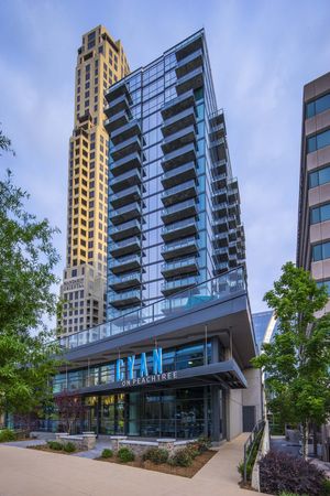 The exterior of the Cyan on Peachtree apartments in Atlanta, GA, featuring a sign that reads "Cyan on Peachtree."