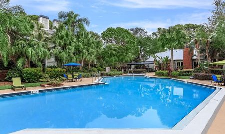 Outdoor pool with lounge seating at apartments in Clearwater, FL.