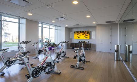 Zinc Apartments' fitness center equipped with spin cycles.