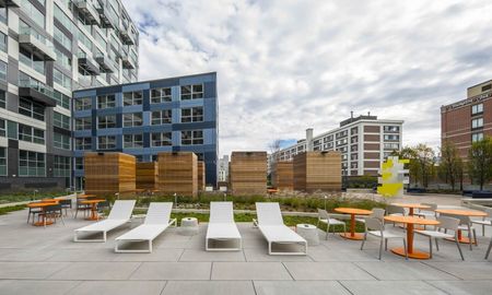 Zinc Apartments outdoor patio with seating and art.