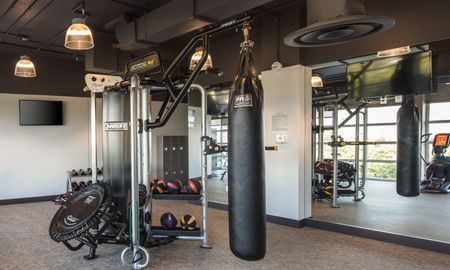 Fitness center with free weights at a rental community in Miami.