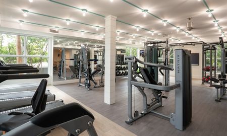The fitness center at our apartments for rent in Pompano Beach, FL, featuring free weights and exercise machines.
