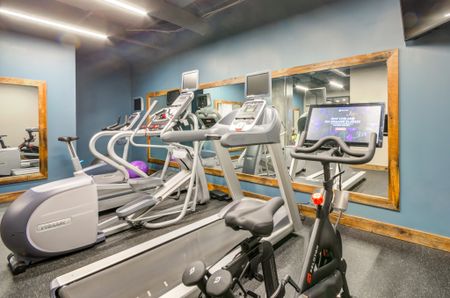 Fitness center at our apartments for rent in Washington DC, featuring treadmills, exercise bikes, and more.