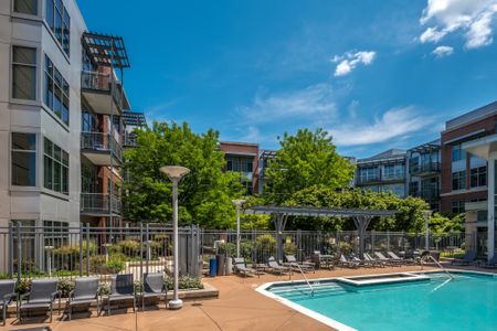 The pool area at our apartments for rent in McLean, featuring beach chairs and a view of the sparkling pool.