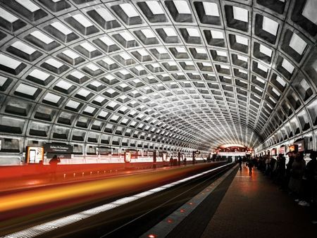 The metro station near our apartments for rent in Washington DC, featuring a view of the arched ceiling and platform.