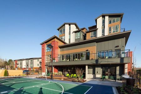 Exterior view of Spencer 68 apartments near Bothell WA, with a pickleball court beside them.
