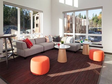 Seating area with orange puffs on the second floor in the community center.
