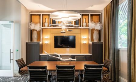 Meeting room with a television in the Franklin Delray for residents to use for remote work.