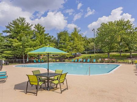 The pool area at our apartments in Antioch, featuring beach chairs, umbrellas, and outdoor tables with chairs.The pool area at our apartments near Antioch Park, featuring beach chairs, umbrellas, and outdoor tables with chairs.