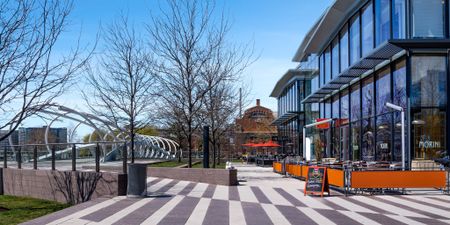 A public plaza near our apartments for rent in Washington DC, featuring eateries with outdoor dining areas out front.