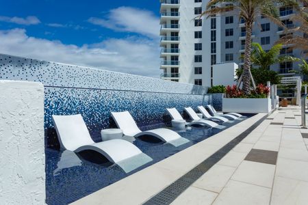 Pool lounge chairs outside high rise apartments Fort Lauderdale.