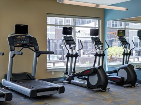Close up image of three treadmills within the exercise center at Everly apartments, located near Reading MA.