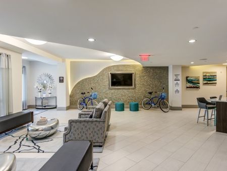 Boca City Walk Apartments lobby with bicycle leaning against the wall.