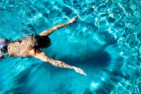 Man swimming in pool