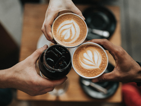 hand cheersing coffee