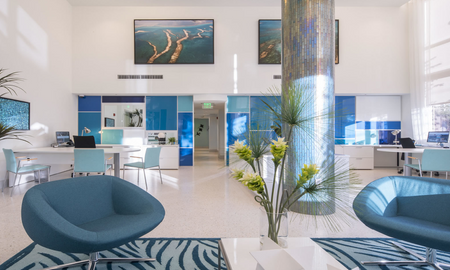 Leasing office with blue accents inside SOMA at Brickell apartments in Miami.