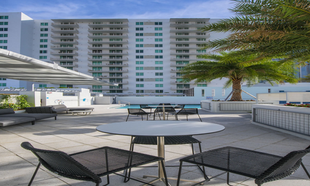 Outdoor lounge at our apartments for rent in Miami, featuring outdoor seating and a view of the apartment complex.