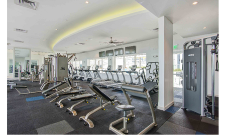 The fitness center at our apartments in Brickell, featuring treadmills, spin bikes, and other exercise equipment.