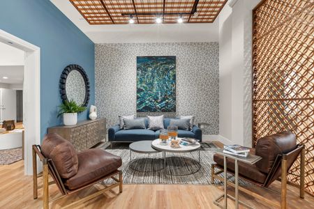 lounge are with brown leather chairs and blue couch