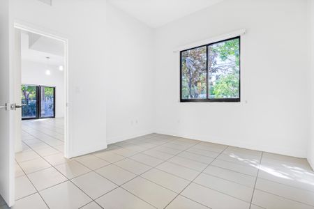 Bedroom photograph of living and lining area at townhome unit in Miami, FL.