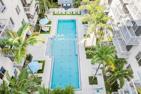 Resort-style pool surrounding by luxury apartment buildings in Boca Raton Florida.