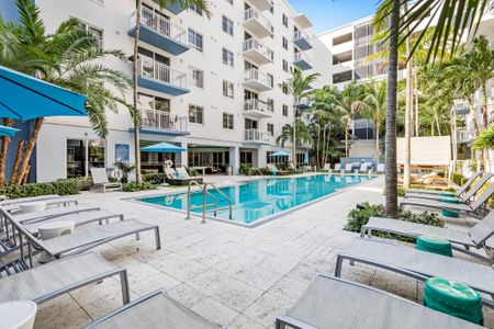 Resort-style pool surrounding by luxury apartment buildings in Boca Raton Florida.