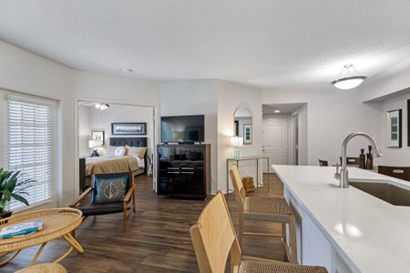 Close up view of a luxury Palm Beach Florida apartment kitchen with white wood cabinetry and stainless steel appliances.