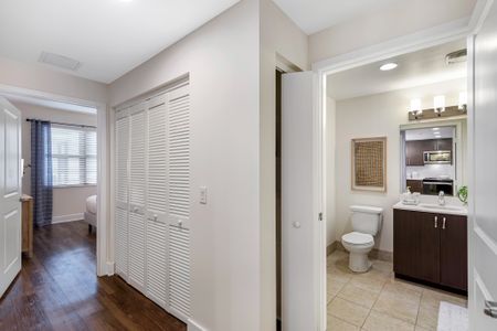 Model bathroom at our apartments in Boca Raton, featuring tile floor paneling and a bath as well as a shower.