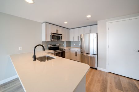 Newly updated kitchen with stylish backsplash and plenty of counterspace.
