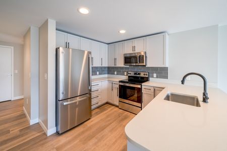 Newly updated kitchen with stainless steel appliances, stylish backsplash and plenty of counterspace.