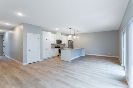 vacant living room and kitchen with hard surface floors