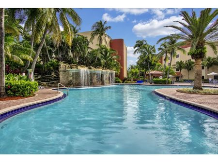Fontainebleau Milton Apartments, exterior, palm trees, foliage, path to pool and waterfall area