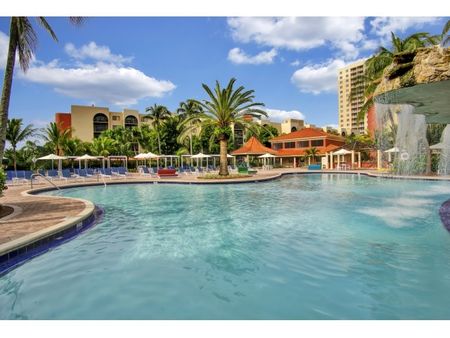 Fontainebleau Milton Apartments, exterior, sparkling blue swimming pool, water fall, palm trees