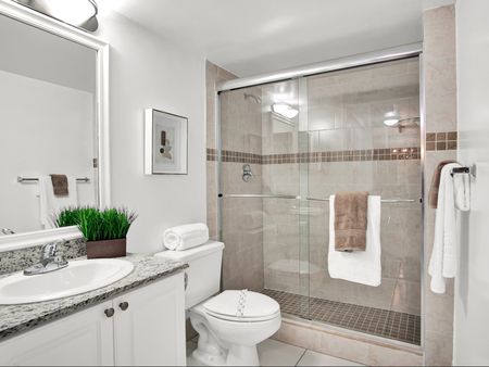 Model Unit 128 - Bathroom with Granite Countertops and Glass Shower Enclosures