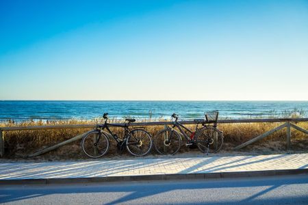two bikes next to the ocean