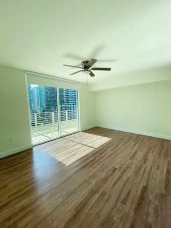 Ceiling Fan and Wood Plank Flooring Throughout