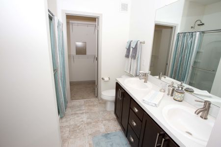 Bathroom with double vanity and shower