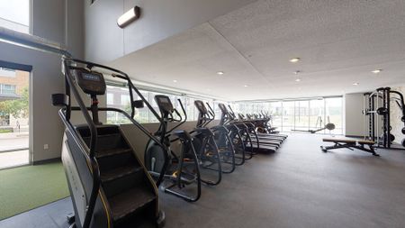 Exercise equipment in fitness center at  LINC at Gray's Station apartments