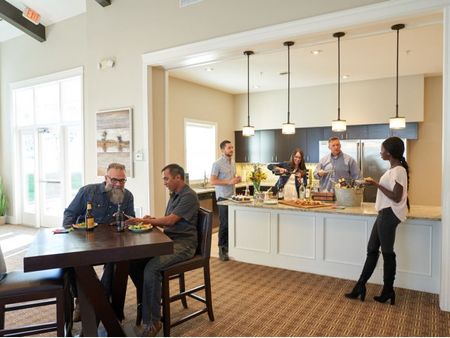 Residents Snacking in the Kitchen | Apartments Waukee, Iowa | The Winhall of Williams Pointe